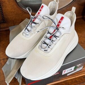 Authentic  White Mesh Sneakers with Red Logo. Comes with Box and dust bag